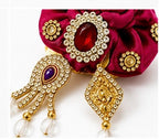Elegant Magenta Rose Laddu Gopal Shringar Accessory with Sparkling Rhinestones, Jewels, Gold Detailing, and Pearl Drops.
