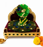 Premium green Kanha poshak decorated with natural peacock feathers and sparkling crystal embellishments.