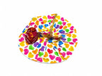White Laddu Gopal poshak with vibrant heart prints, golden lace, and matching maroon pagdi.