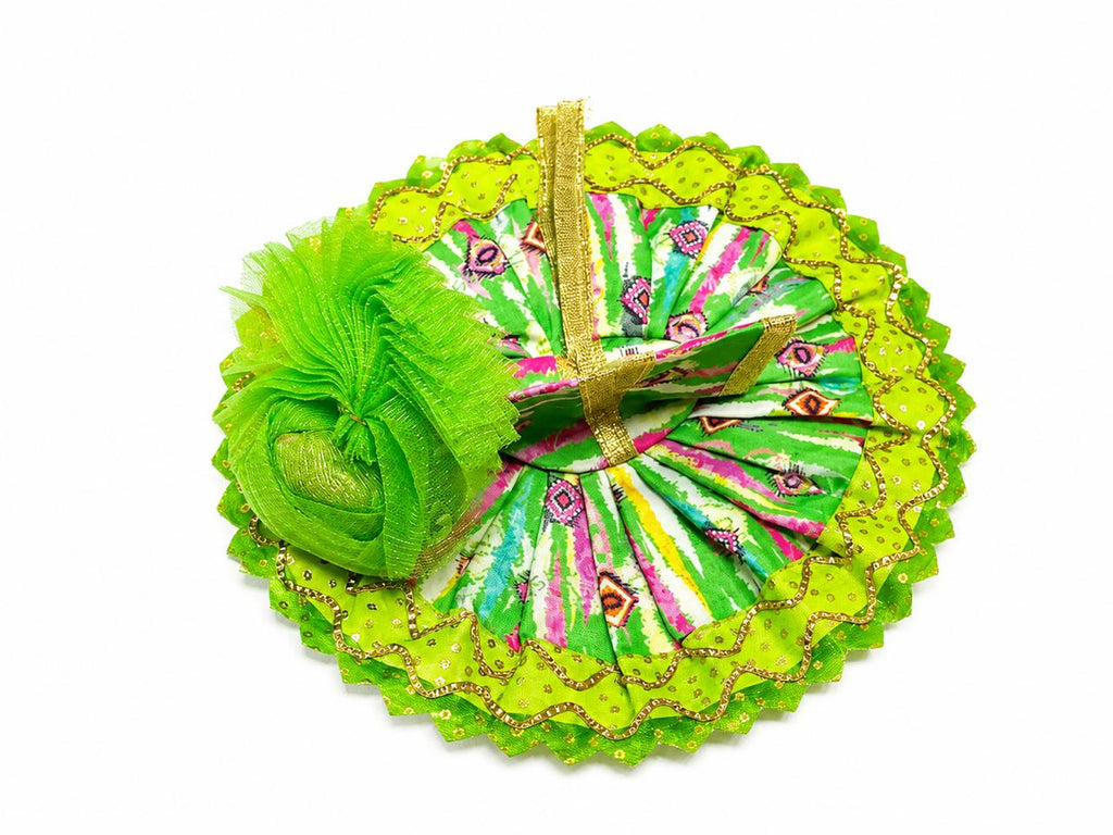 Handcrafted green Laddu Gopal outfit adorned with traditional prints and sparkling golden detailing.